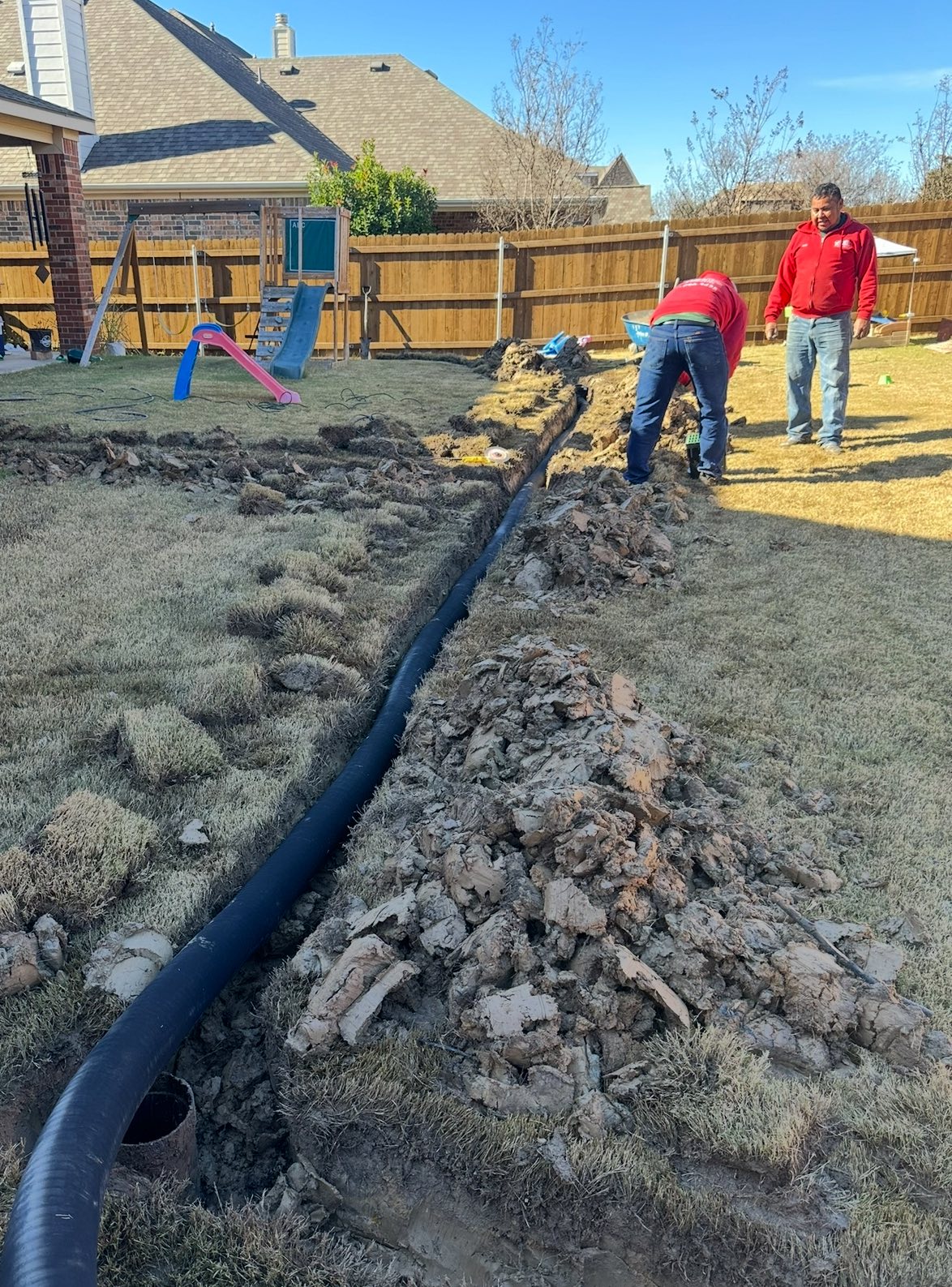 Drainage pipe installation across backyard