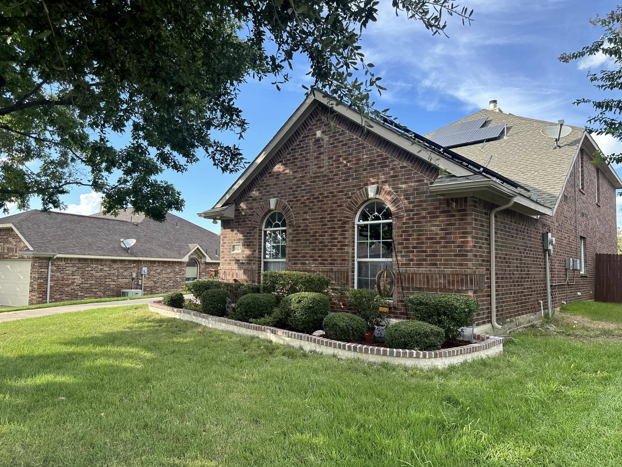 Front yard landscaping with curved bed borders