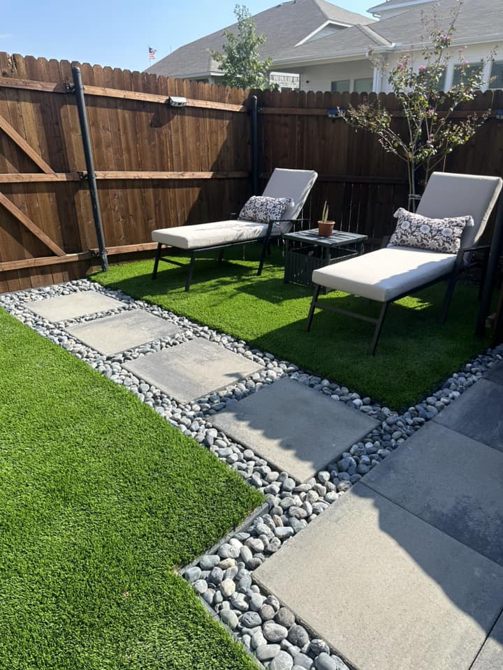 Modern outdoor lounge with pavers, turf, and seating