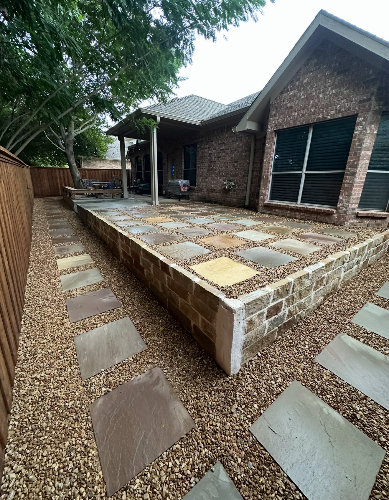 Paver patio with stone retaining wall
